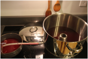 Juice is collected in the funnel, water is in the bottom pot and the strainer/basket of fruit sits on top of this funnel.